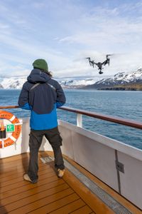 Drone operator Raphael Boudreault-Simard flies an drone in the Southern Ocean. (National Geographic for Disney/Ruth Davies)