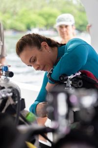 Dr. Alex Schnell prepares her SCUBA gear on board a dive vessel in the Lembeh Strait.  (National Geographic for Disney/Craig Parry)