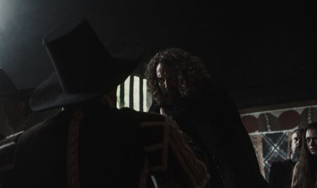 Matthew Hopkins sneers at the council as he is accused of forced confessions and possible involvement in witchcraft. (Dash Productions Services LTD/Antoan Ivanov)