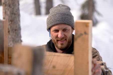 Johnny Rolfe builds his dog Java a box seat that will attach to his sled. (BBC Studios Reality Production/Patrick Henderson)