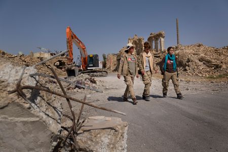 Sinjar, Iraq - Three deminers walk through Sinjar town. (Sean Sutton)