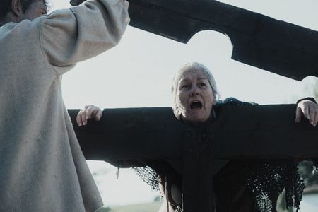 Janet Liston's mouth hangs open as she puts her hands onto a pillory. (Dash Productions Services LTD/Antoan Ivanov)