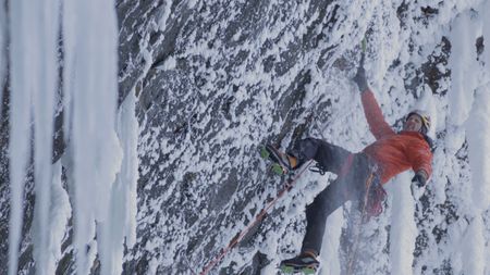 Will Gadd clears snow and ice from the wall as he climbs Helmcken Falls.  (mandatory credit: Red Bull Media House)