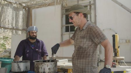 Maritime archaeologist Alessandro Ghidoni and craftsman Ayaz Al-Zadjali work on location in Qantab, Oman. (Windfall Films)