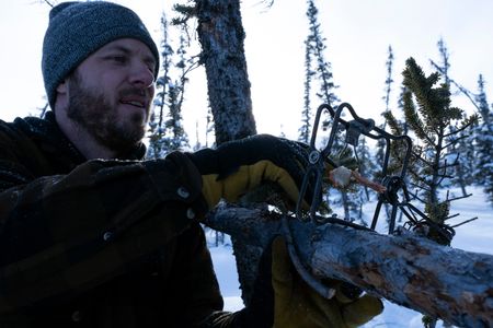 Johnny Rolfe sets a conibear  trap before the prime fur trapping season is over.(BBC Studios Reality Productions, LLC/Tyler Colgan)