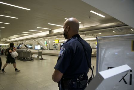 CBP Officer Ramos is standing and assessing the baggage claim area at the JFK International Airport.(National Geographic)