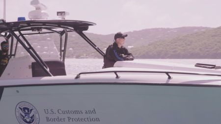 CBP AMO Agents gaze over the bow of a boat. (Lucky 8 TV/Sharon Manente)