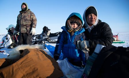 Agnes and Chip Hailstone teach their grandson, Sabastian how to ice fish during the winter season. (BBC Studios Reality Productions, LLC/JR Masters)