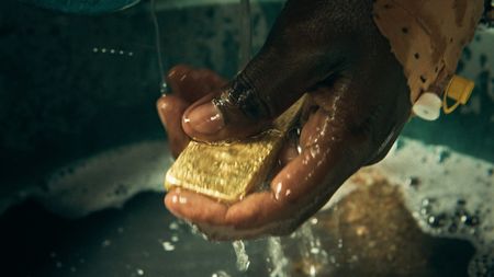 A gold bar is washed in Algadez. (National Geographic for Disney)