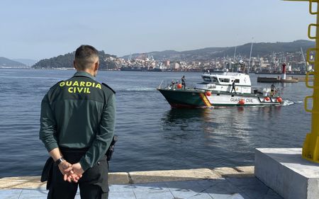 A guard watches the arrival of his colleagues from the dock of the port in Vigo, Pontevedra, Spain. (National Geographic/Juan Antonio Domínguez)