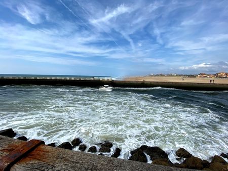 Waves break at the pier of Hossegor, France, on a day of blue sky.  (National Geographic/Gene Gallerano)
