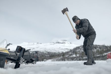 Joel Jacko cuts through the ice to use his saw mill. (National Geographic/Wayne Shockey)