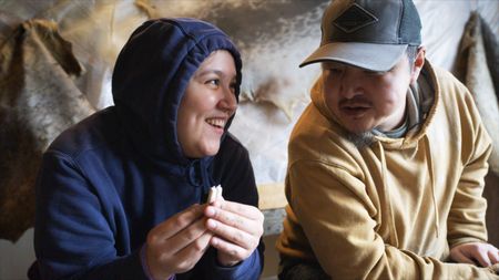 Nalu Apassingok carves earrings out of walrus tusk with her father, Daniel Apassingok. (National Geographic)