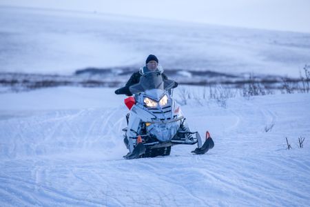 Agnes Hailstone travels by snowmobile across the tundra near her camp in Kiwalik. (BBC Studios Reality Production/Ashton Hurlburt)