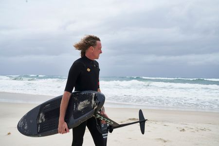 Christian Bungate with his foil board at Cabarita Beach. (National Geographic/Justine Kerrigan)