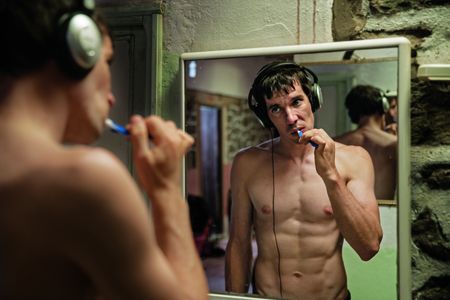 Alex Honnold, 33, listens to music while brushing his teeth as he prepares for a day of climbing in Morocco's High Atlas Mountains, one of several foreign locations where he trained for his attempt on El Capitan. (Jimmy Chin)