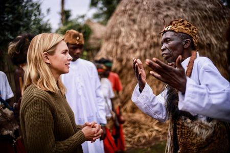 Mariana van Zeller speaks with the Mwani representative and is given a blessing to film in the forest. (National Geographic for Disney)