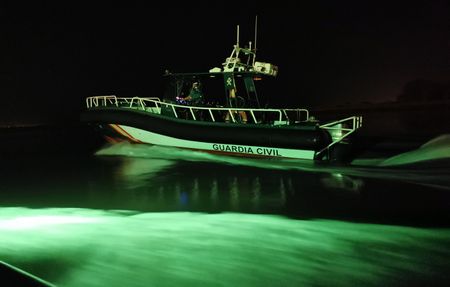 A Civil Guard boat sails at high speed at night.(National Geographic/Antonio Javier López Castillo)