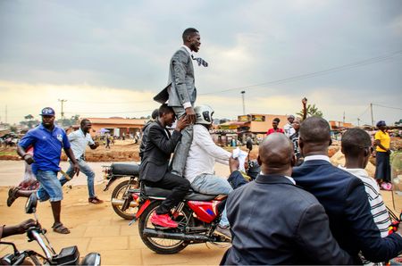 Bobi Wine on a motorbike escaping from police in Uganda Kampala. (Mandatory photo credit: Katumba Badru)