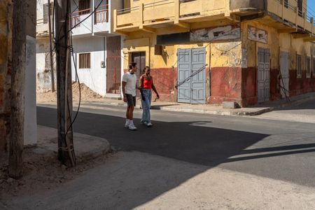 Antoni Porowski and Issa Rae walk through the streets of Saint-Louis, Senegal. (National Geographic/John Wendle)