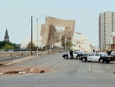 The remains of the Alfred P. Murrah Federal Building are imploded on May 23, 1995. (National Geographic)