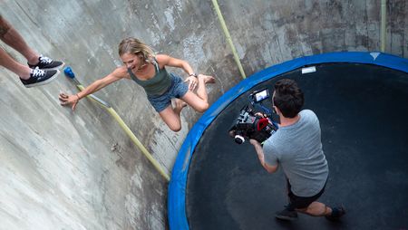 Angel Collinson jumps on a trampoline as cinematographer Nick Kraus films.  (National Geographic/Elena Gaby)