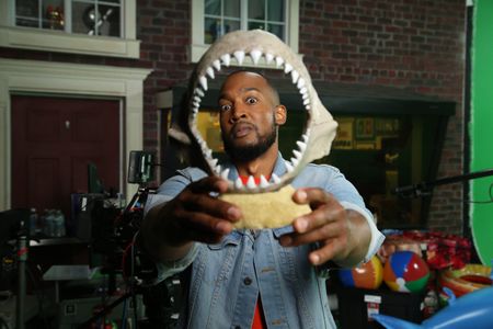 Keon Poole looking in shock, face inside of a display shark jaw. (National Geographic/Robert Toth)