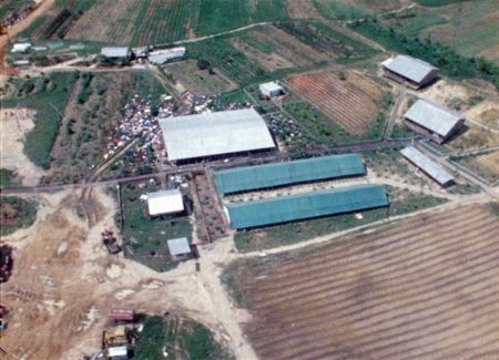The Peoples Temple compound is seen in aerial view as helicopters approach Jonestown. (National Archives and Records Administration)
