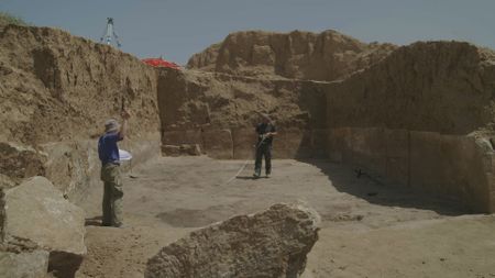 Jan Heiler and Ulrike Buerger measure out a newly uncovered chamber in Mosul, Iraq. (Windfall Films/Ali Hilal Ali Hussain)