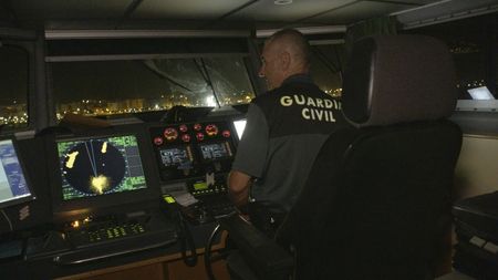 A guard commands a patrol boat in Almería, Spain. (National Geographic)