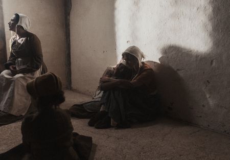 Sarah Good holds Tatabe as they sit on the floor of a prison cell. (Dash Productions Services LTD/Antoan Ivanov)