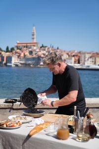 Croatia - Gordon Ramsay plates his risotto with cuttlefish ink during the final cook in Croatia. (Credit: National Geographic/Justin Mandel)
