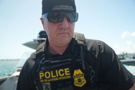 CBP AMO Agent Hud walks on board a boat during an operation in Fajardo, P.R. (Lucky 8 TV/Paul Taggart)