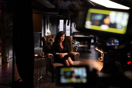 In this behind-the-scenes photo, eewelry designer, historian, scientist and a New York Times best-selling author Aja Raden poses for a portrait during an interview for "Killer Lies: Chasing a True Crime Con Man," a documentary series about obsession and deception, following the unraveling of Stephane Bourgoin’s career as a best-selling author and serial killer expert. (National Geographic/Ben Selkow)