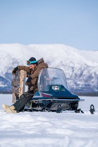 Johnny Rolfe sets fishing lines underneath the ice. (BBC Studios Reality Productions/Patrick Henderson)