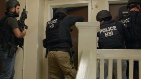 A team of HSI agents conduct a raid of a suspect's residence during an operation. in Los Angeles, Calif. (National Geographic)