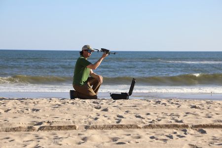 Tim Regan preparing for his drone to take off on the beach. (National Geographic/Mariana Kneppers)