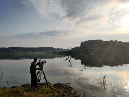 Barrie Britton films the sunrise over Schroda Lake. (National Geographic for Disney/Alex Minton)
