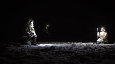 Agnes Hailstone and her daughters ice fish at night. (BBC Studios/Dwayne Fowler)