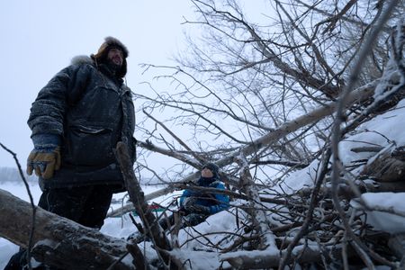 Chevie Roach teaches his son Ryder how to set marten traps along their trapline. (BBC Studios Reality Productions, LLC/Jayce Kolinski)