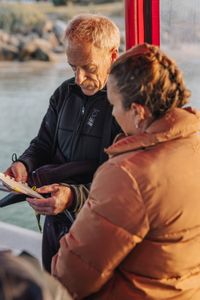 Director and cinematographer, Adam Geiger, runs through a dive plan with storyteller and cephalopod expert, Dr. Alex Schnell before entering the water to film octopus in Port Phillip Bay.  (photo credit: National Geographic/Harriet Spark)