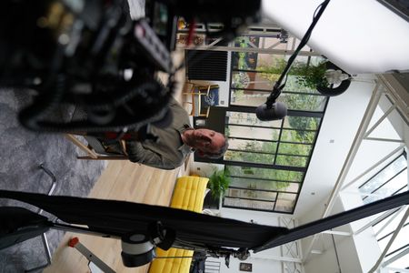 In this behind-the-scenes photo, cinematographer Olivier Raffet is interviewed for "Killer Lies: Chasing a True Crime Con Man," a documentary series about obsession and deception, following the unraveling of Stephane Bourgoin’s career as a best-selling author and serial killer expert. (National Geographic/Ben Selkow)