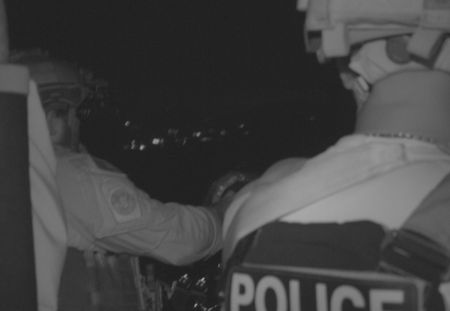 Two CBP Agents ride in a water vessel at night in St Thomas, USVI. (Lucky 8 TV/Paul Taggart)