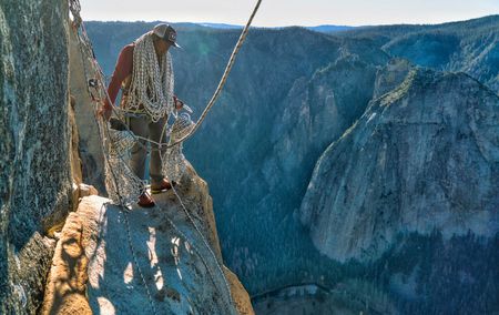 Jimmy Chin with 1500ft of rope coiled and ready to rappel down the wall to get into position for a day of shooting.  (National Geographic/Cheyne Lempe)