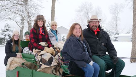 Clinic staff members Katelyn Fischer, Laurel Driver, Dr. Erin Schroeder, Val Sovereign, Julie Hochstein, and Dr. Ben Schroeder prepare for a sleigh ride. (National Geographic)