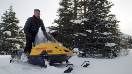 Joel Jacko on a snowmobile looking for birds. (National Geographic)
