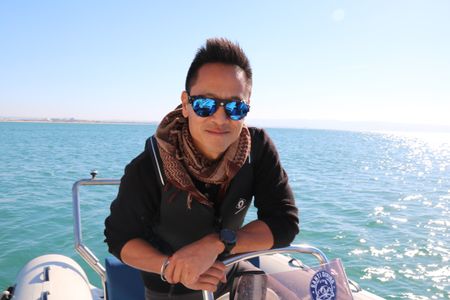 Acre, Israel - Dr. Albert Lin on a speed boat outside the harbour of Acre, Israel. (Blakeway Productions/National Geographic)