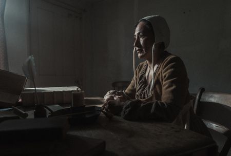 Sarah Osborne sits at an interrogation table. (Dash Productions Services LTD/Antoan Ivanov)