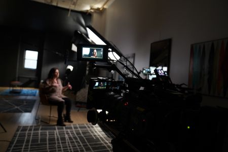 In this behind-the-scenes photo, member of the 4th Eye Corporation "Elora" is interviewed for "Killer Lies: Chasing a True Crime Con Man," a documentary series about obsession and deception, following the unraveling of Stephane Bourgoin’s career as a best-selling author and serial killer expert. "Elora" is a pseudonym; she chose to remain anonymous. (National Geographic/Ben Selkow)