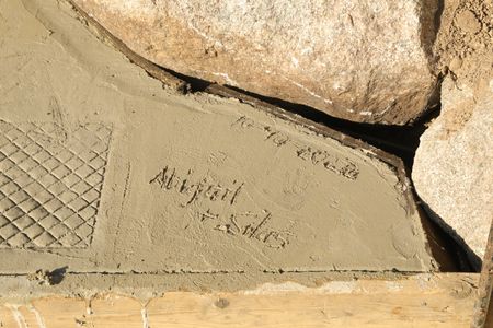 Abigail and Silas Pol's names and the date dry in the sheep hut's new concrete ground. (National Geographic)